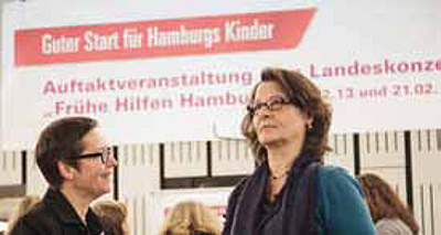 Zwei Frauen vor Plakat zur Auftakveranstaltung